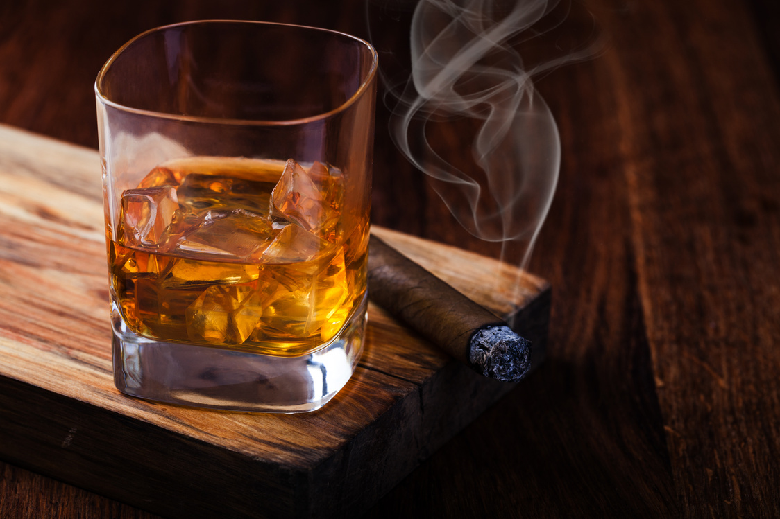 Glass of Whiskey and Lit Cigar on Wooden Board